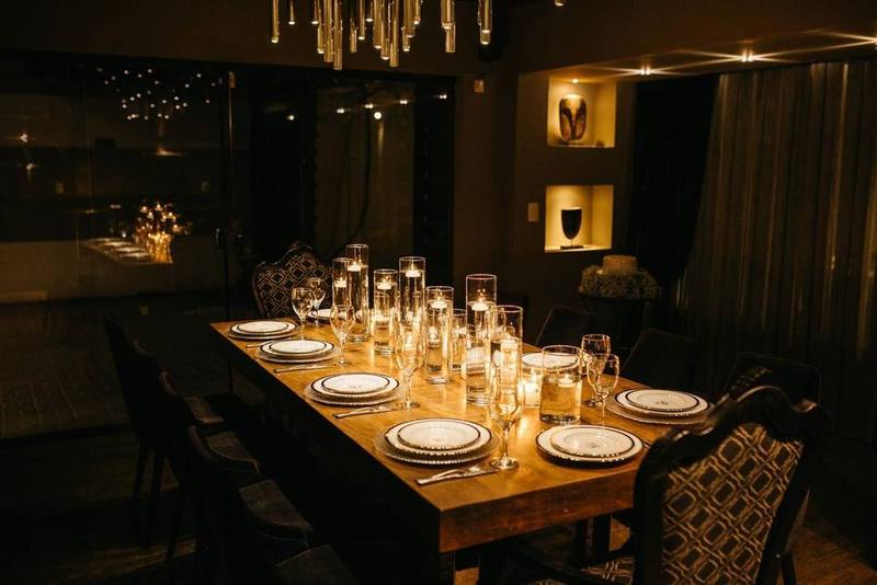 Candlelit private dining room set for a dinner